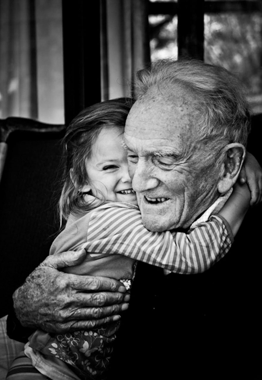 Great grandfather and child hugging