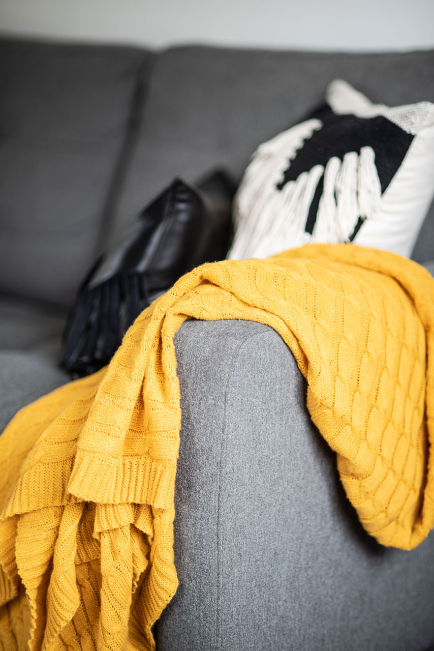 mustard throw on grey couch