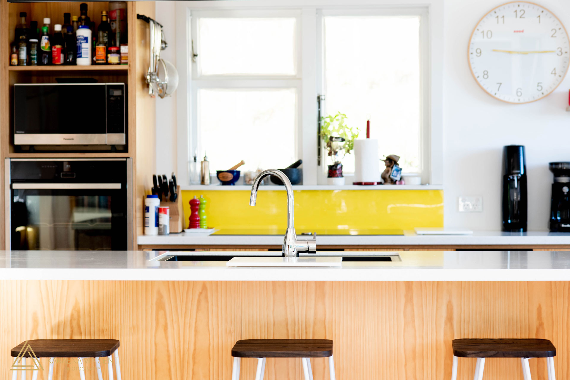 Plywood kitchen with yellow splash back