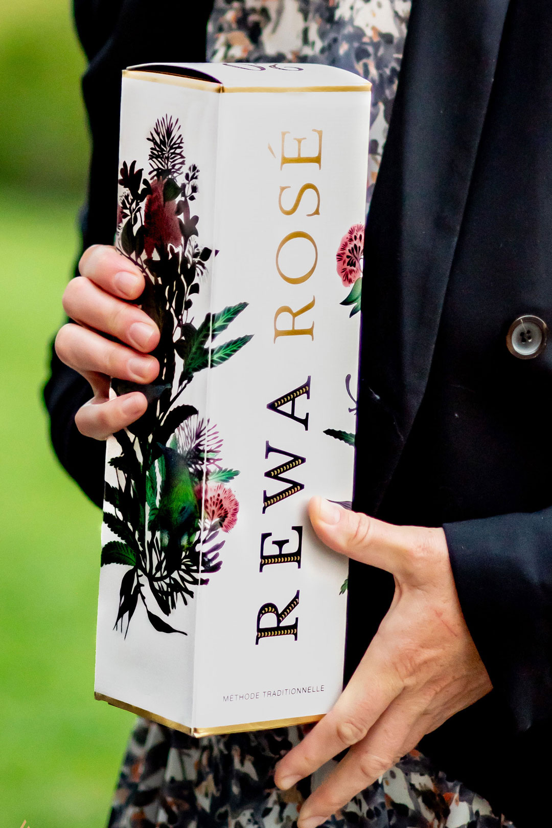 Rewa rose wine in box held in a woman's hands